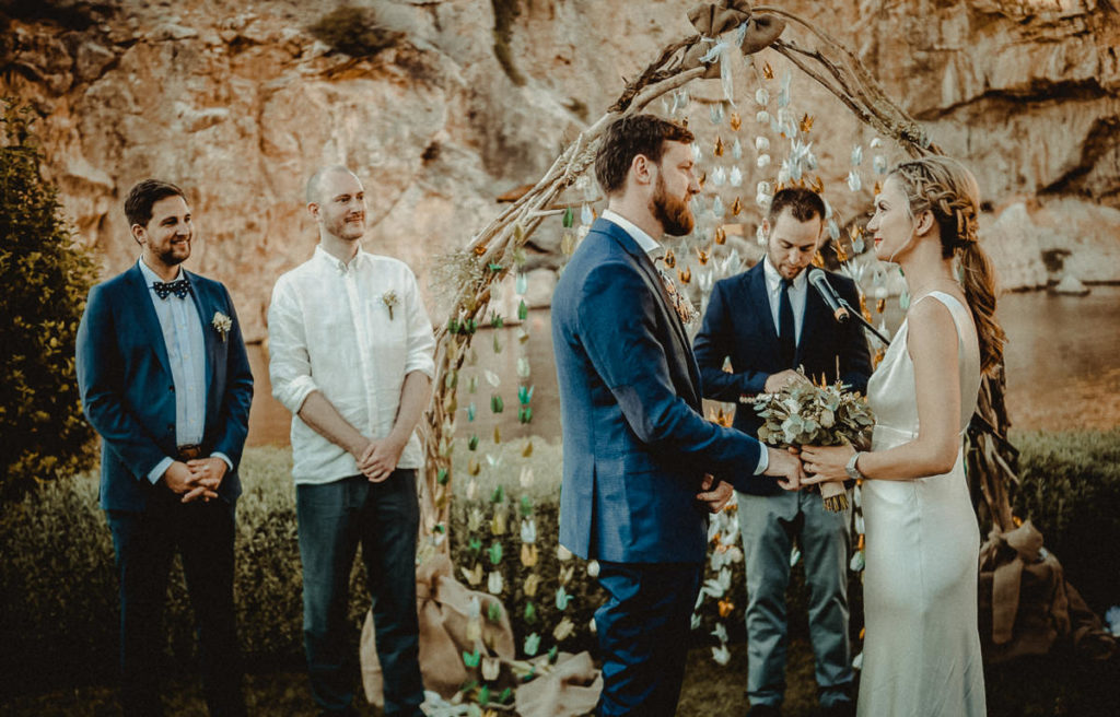 Athens Riviera Wedding Videographer filming ceremony in Lake Vouliagmeni