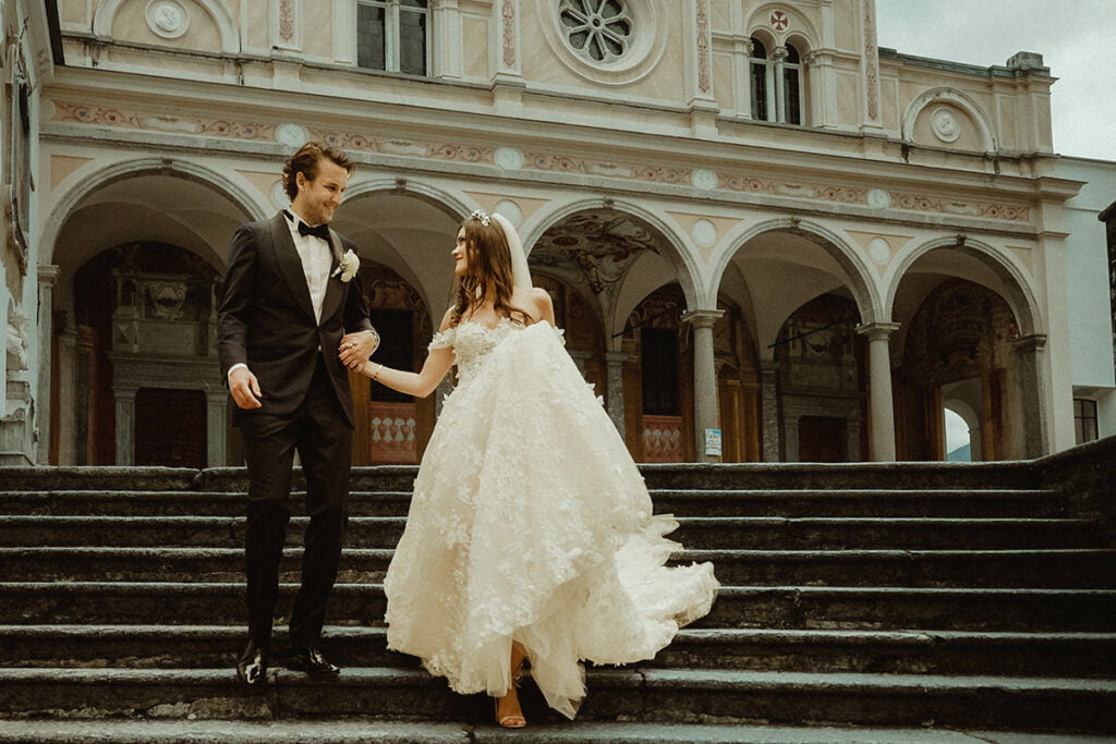couple exiting Madonna del Sasso Sanctuary after their destination wedding in Ticino Switzerland