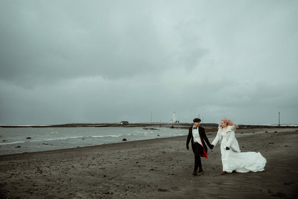 wedding couple walking on a shore in Iceland in the winter