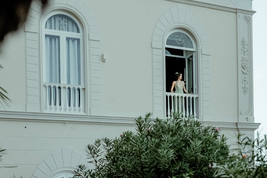 Bride looking from the balcony of Villa Astor in Sorrento in her pre Wedding Dress