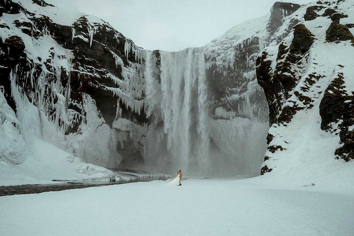 Best Elopement Films: Wedding Couple in front of a waterfall in Iceland