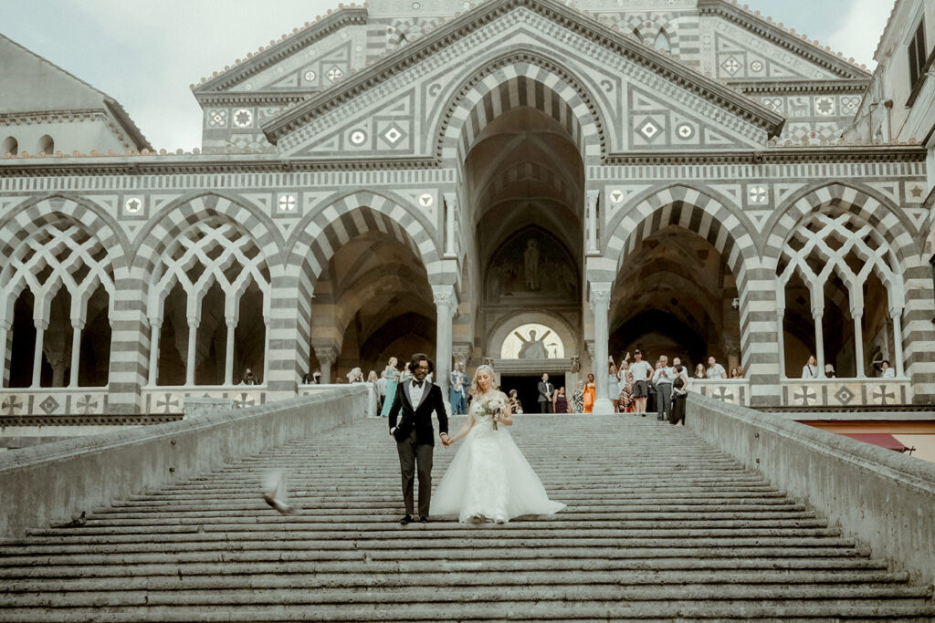 Wedding couple walking down the stairs of Amalfi Duomo