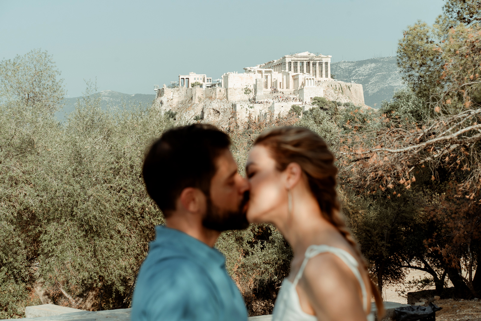 Couple kissing under the Acropolis filmed by an Athens Wedding Videographer