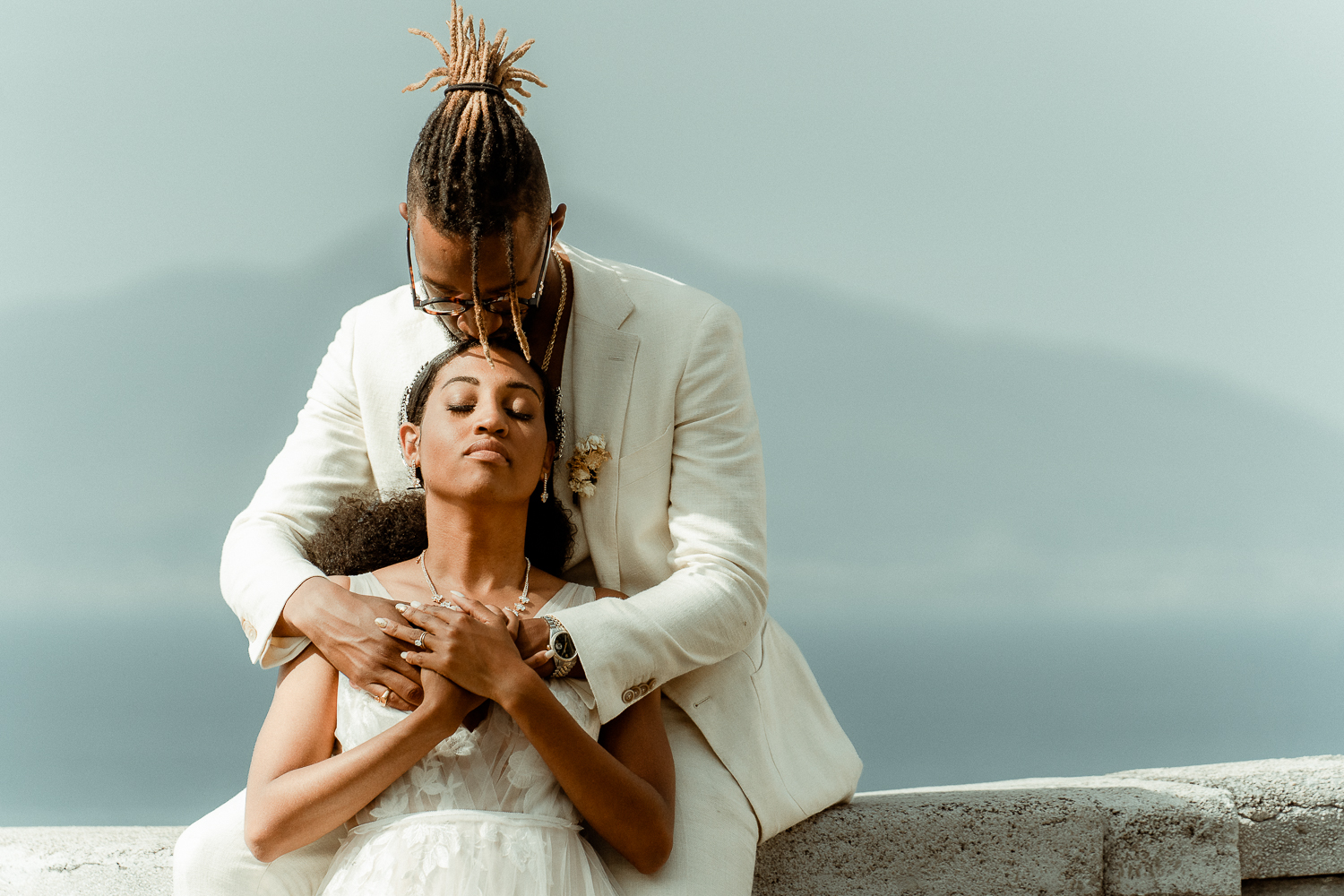 Groom kissing his bride's forehead, a black couple in Sorrento filmed by their Elopement Videographer for Intentional and Intimate Celebrations