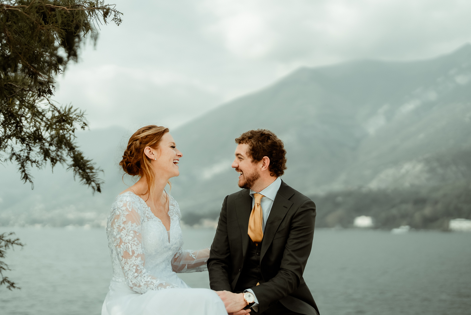 A couple laughing sitted in the Gardens of Villa Melzi after their Lake Como Elopement in Villa Monastero