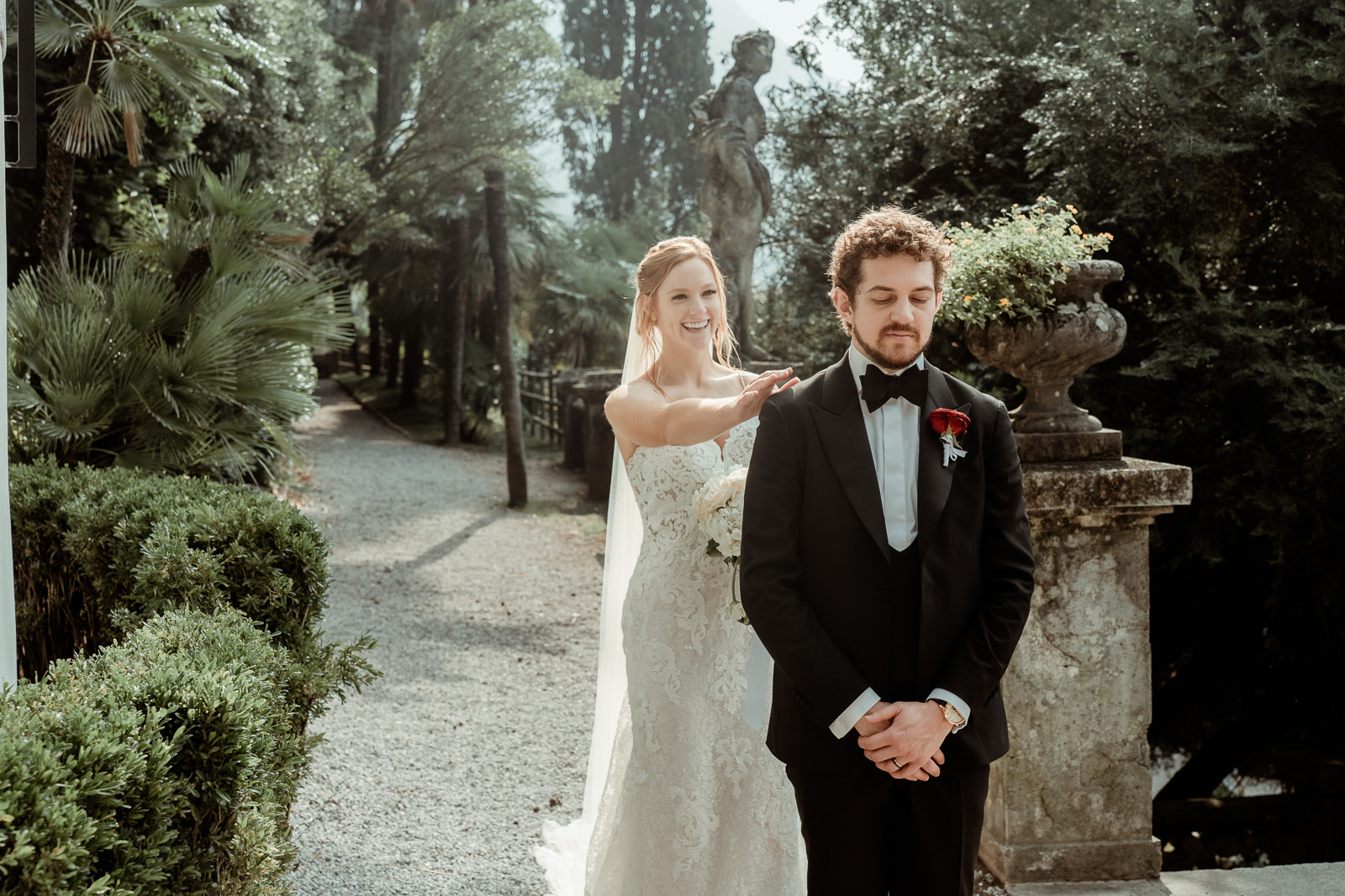 Bride taps the shoulder of her groom for a first look before an Intimate Lake Como Elopement at Villa Monastero