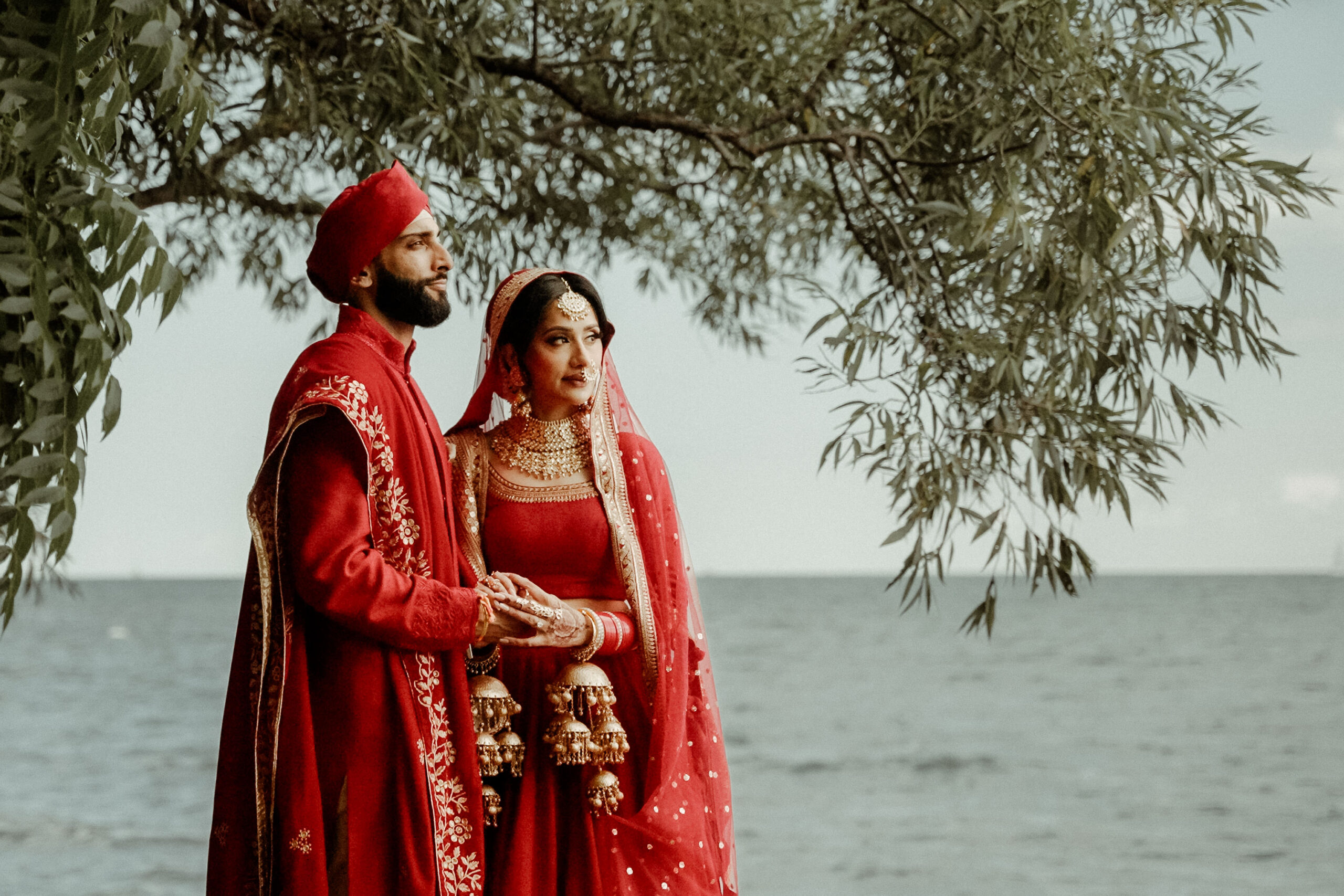 Couple in Indian Wedding attire in front of the sea in Riviera Maya filmed by a Mexico Wedding Videographer