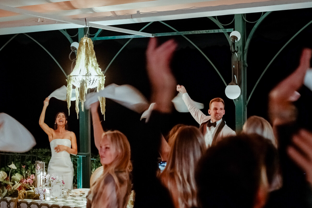 Guests waving white napkins during the party after a Palazzo Avino Wedding in Ravello