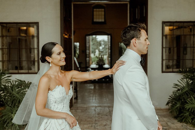Bride tapping the shoulder of her groom for a first look before their Castello Marchione Wedding in Puglia