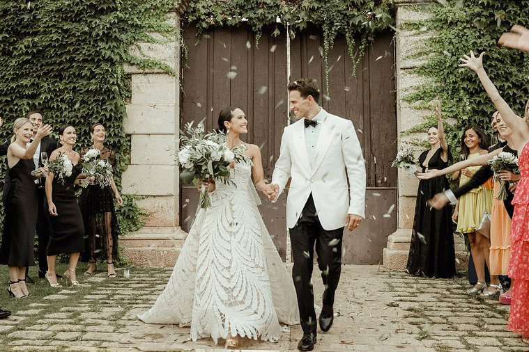 Ceremony exit for a couple after their Castello Marchione Wedding in Puglia, guests cheering and throwing olive leaves on them