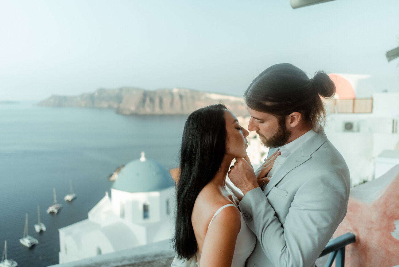 How to Plan a Destination Wedding in Greece, What to Know Before You Begin 4 A couple in Oia after their romantic Santorini Elopement at Dana Villas