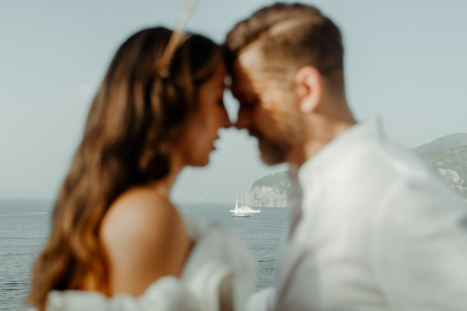 Wedding Couple touching foreheads in front of the sea filmed by a Sorrento Wedding Videographer