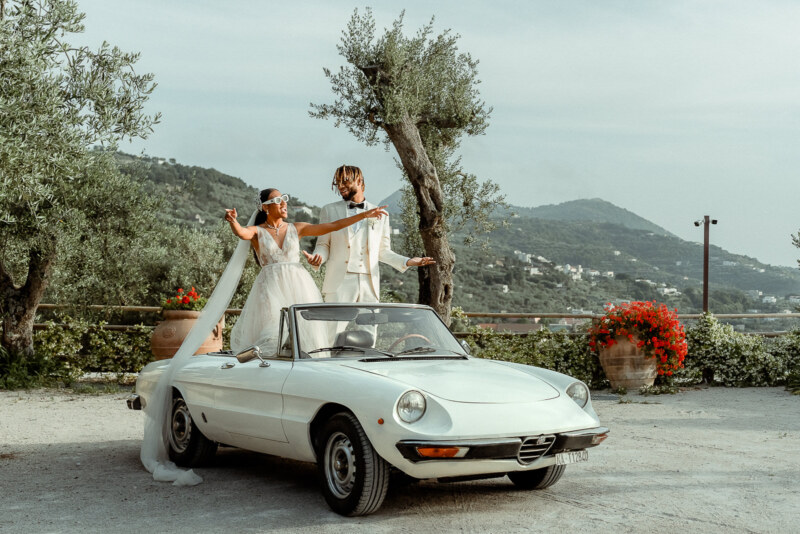 Black Love on the Amalfi Coast - Destination Wedding at Villa Eliana, Sorrento 1 Black couple dancing on a vintage Alfa Romeo cabrio car after their Villa Eliana Sorrento Wedding