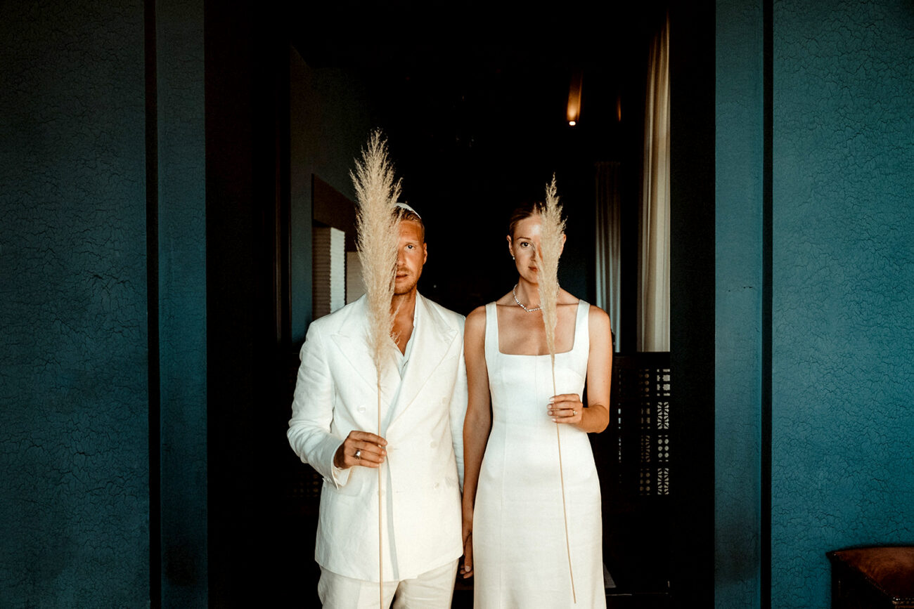 Alternative Wedding Videographer 7 A couple holding pampas that cover one of their eyes filmed by an Alternative wedding videographer