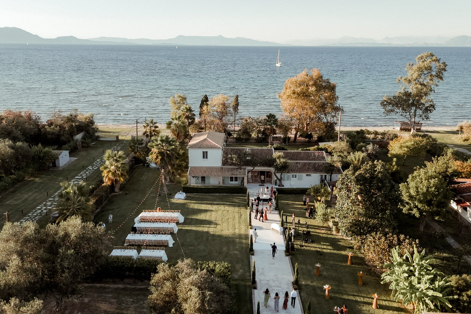 Indian Destination Wedding in Corfu at Natura Estate 2 Aerial view of the Natura Estate, with a dinner setup for an Indian Destination Wedding in Corfu