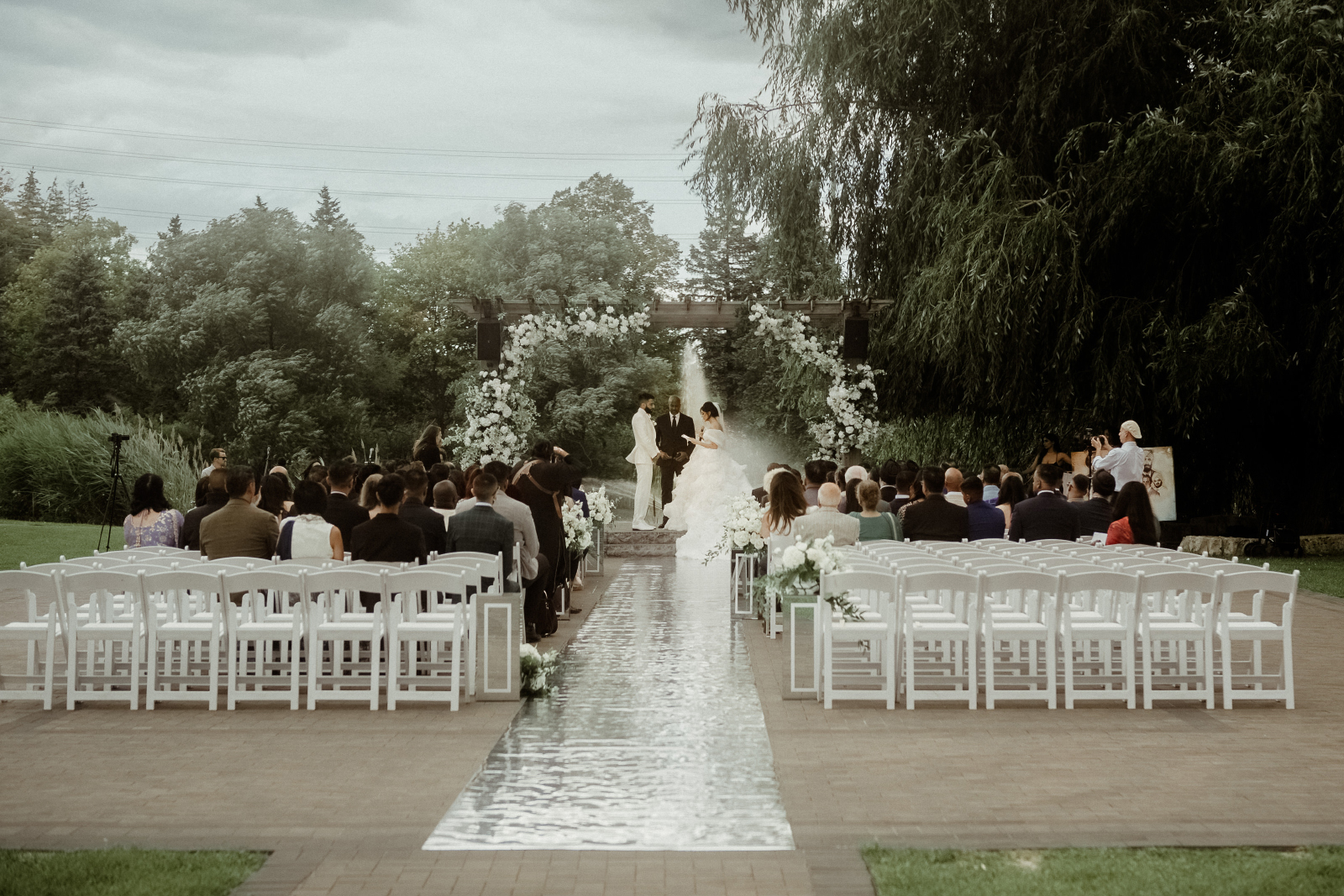 Sikh Wedding in Toronto - A Story of Faith and Reflection 5 A couple in wedding attire during their outdoor civil ceremony at Arlington Estate as part of their Sikh Wedding in Toronto