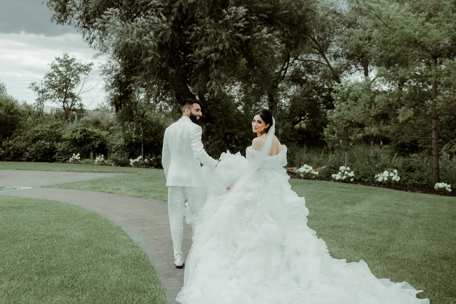 Sikh Wedding in Toronto - A Story of Faith and Reflection 8 A couple in western wedding attire holding hands outdoors after their civil ceremony part of their Sikh Wedding in Toronto