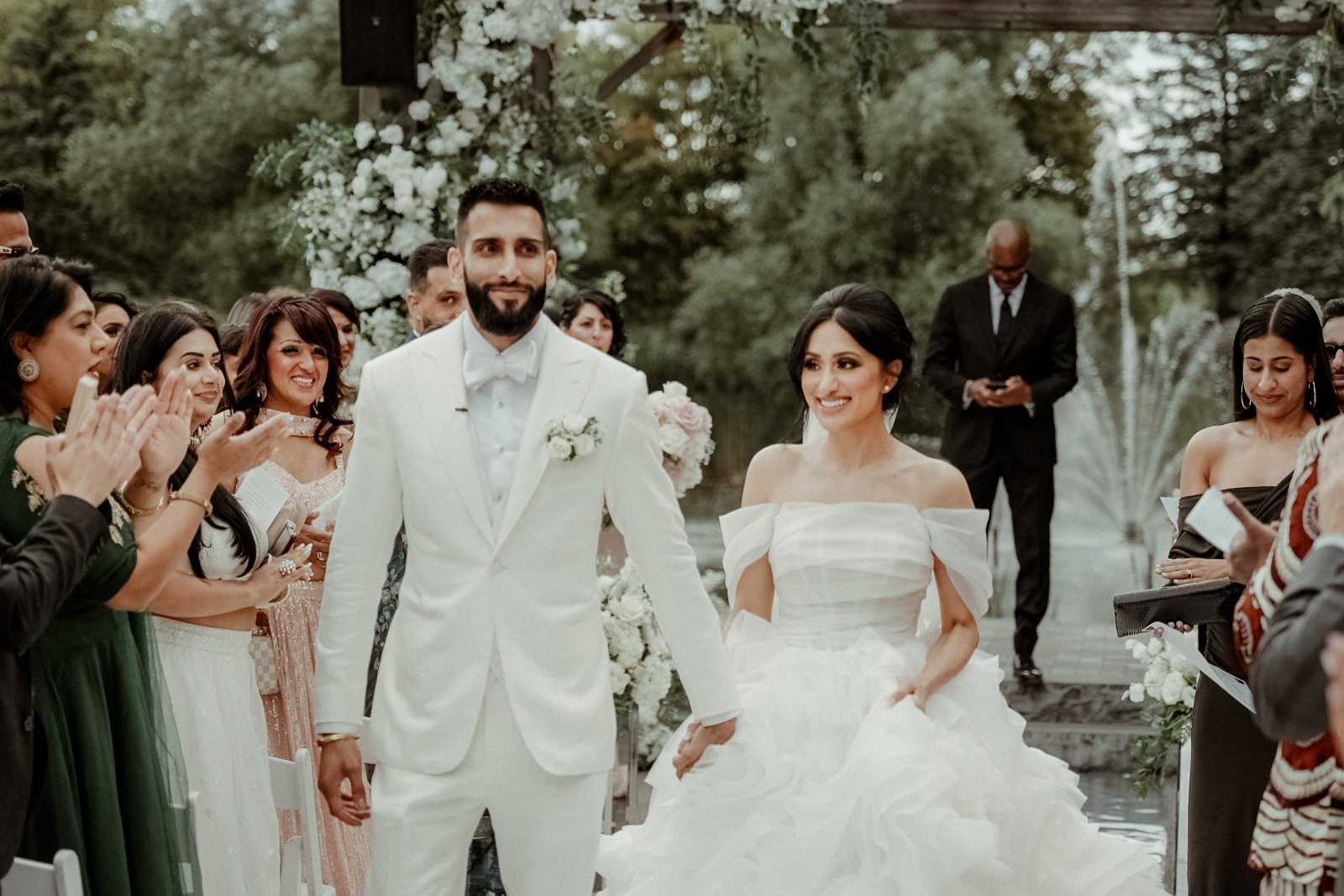 Sikh Wedding in Toronto - A Story of Faith and Reflection 6 A couple in wedding attire holding hands exiting their civil ceremony after a Sikh Wedding in Toronto