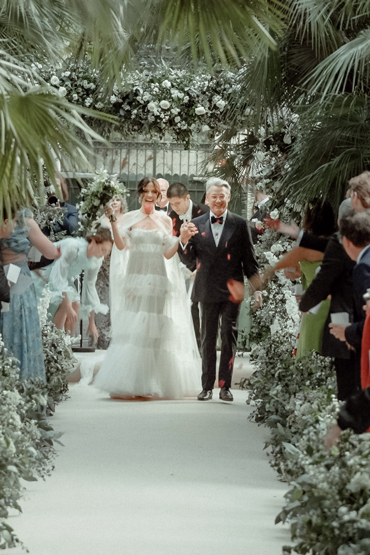 A couple walks down the aisle exiting their wedding ceremony in Villa Astor filmed by their Amalfi Coast Wedding Videographer
