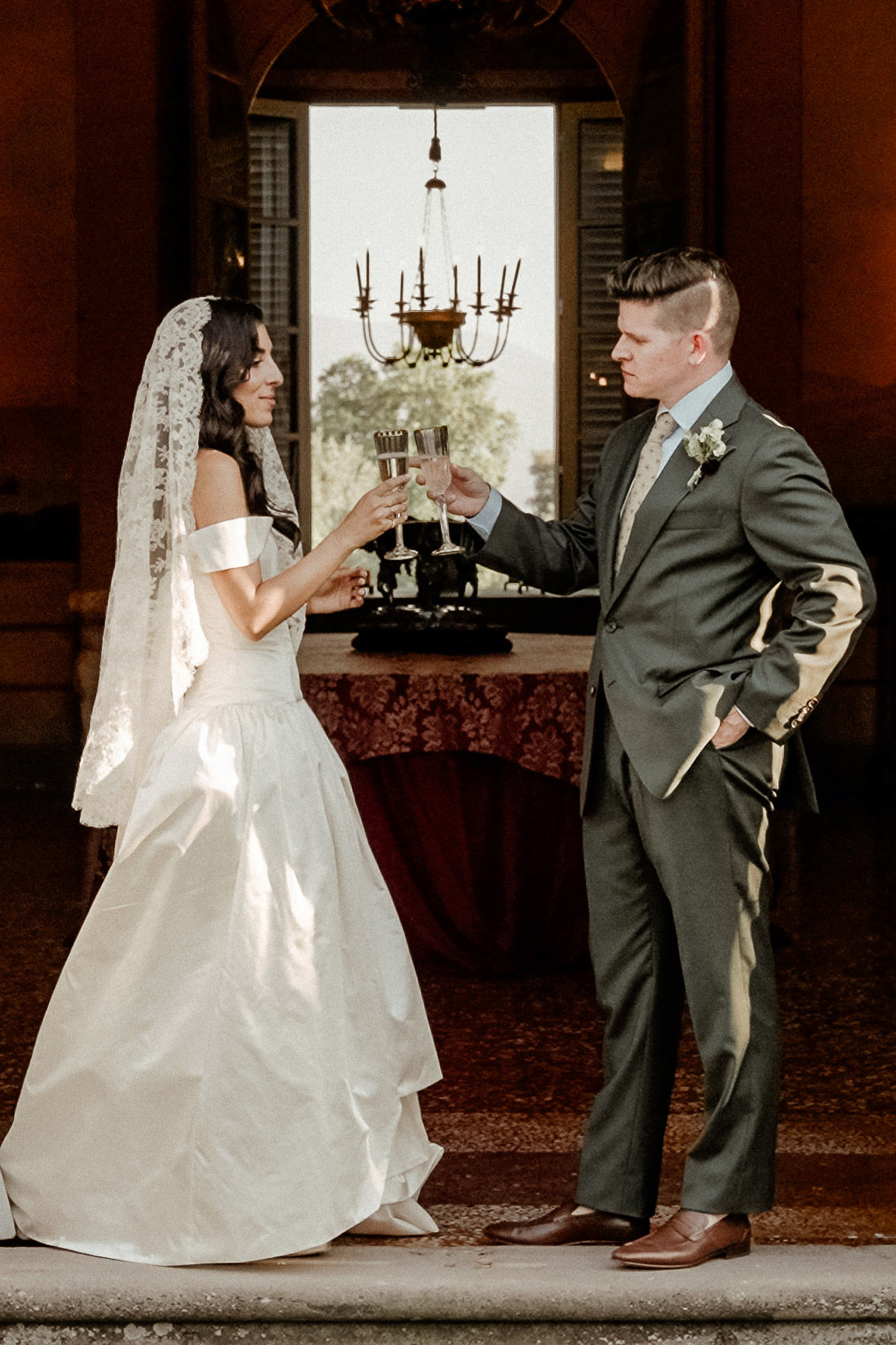 A Wedding Couple holding champagne glasses as an illustration for Wedding Videography Investment