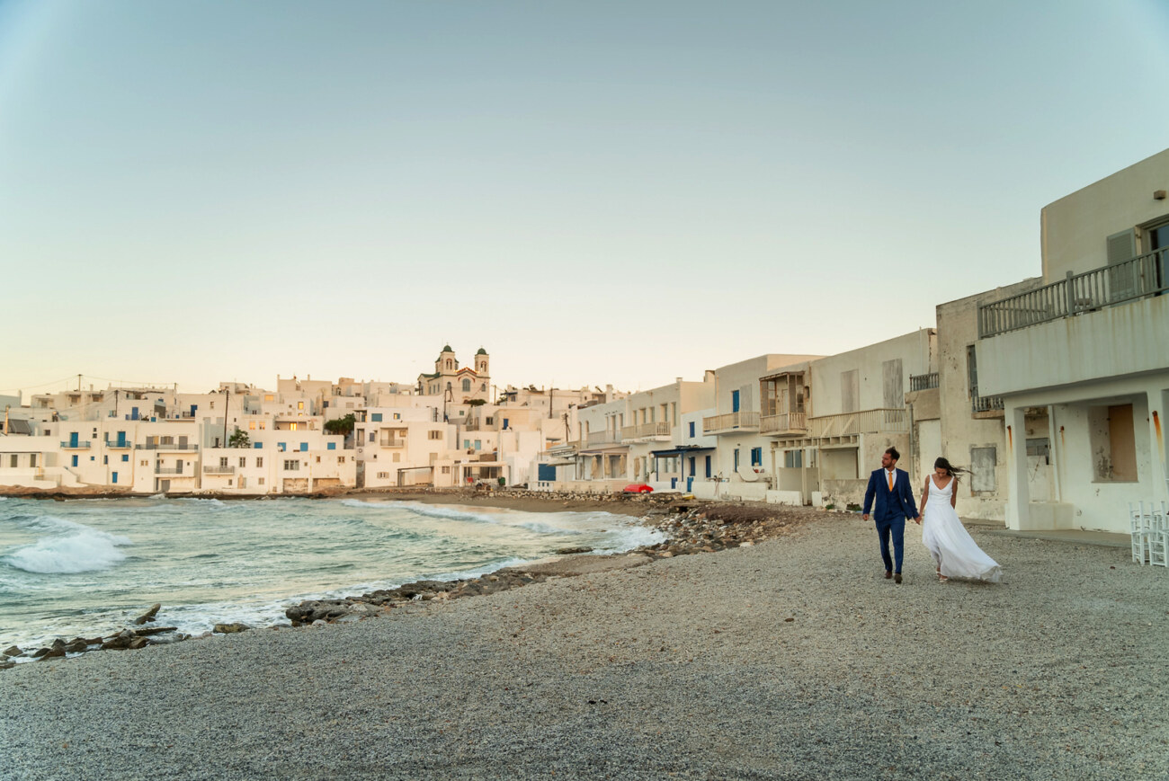 How to Plan a Destination Wedding in Greece, What to Know Before You Begin 15 A Wedding couple walking hand in hand in Paros Naoussa