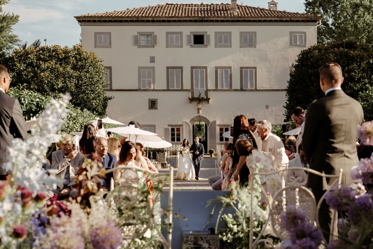 Bride walking down the aisle for her destination wedding in Italy, Villa Grabau is visible in the background