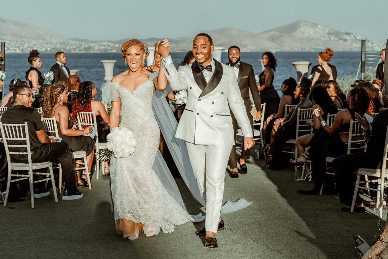 Wedding videographer in Greece filming an outdoor destination wedding ceremony