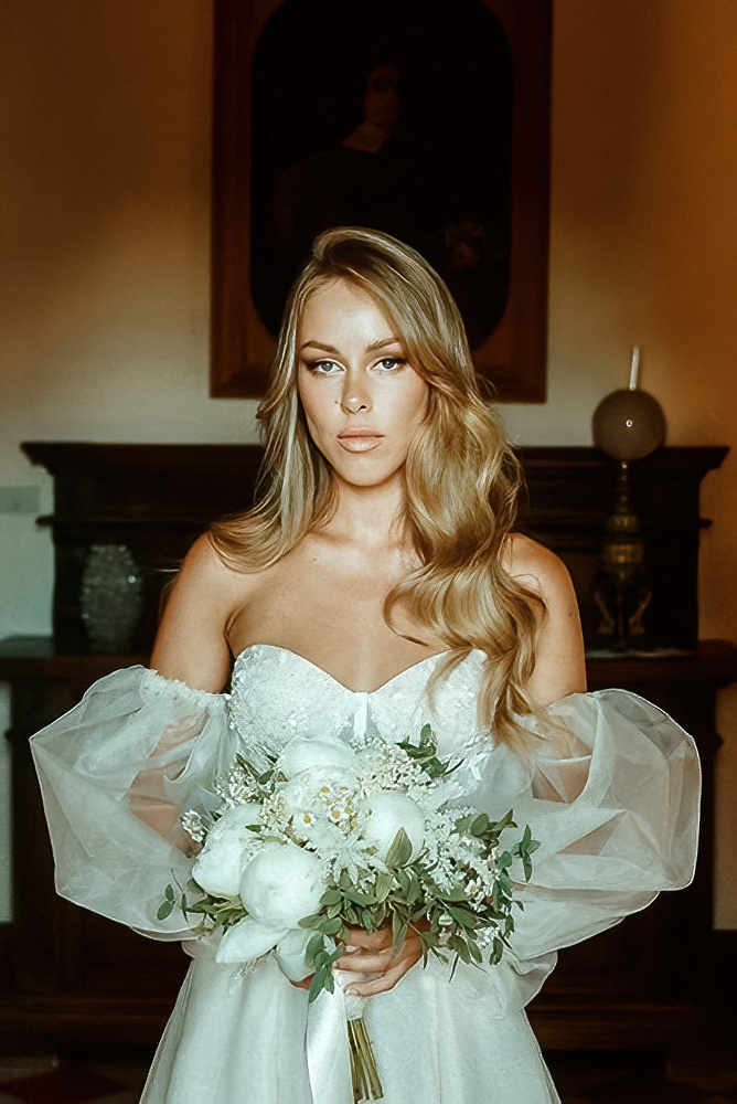 A bride holding her flower bouquet filmed by an alternative wedding videographer for a fine art wedding film