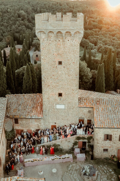 Group picture at Castello di Gargonza, one of the best wedding venues in Tuscany
