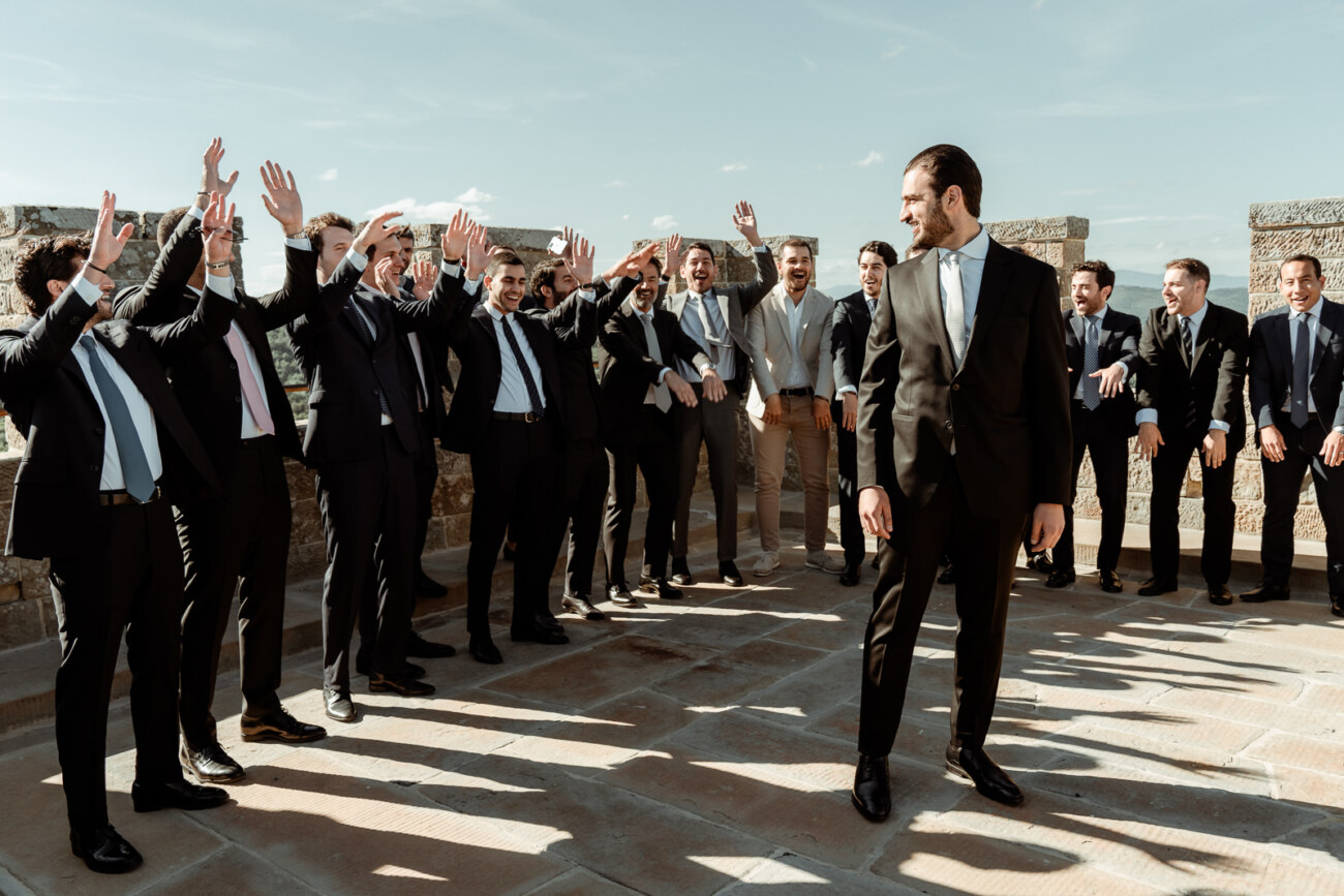 Groom party at the tower of Castello di Gargonza in Tuscany