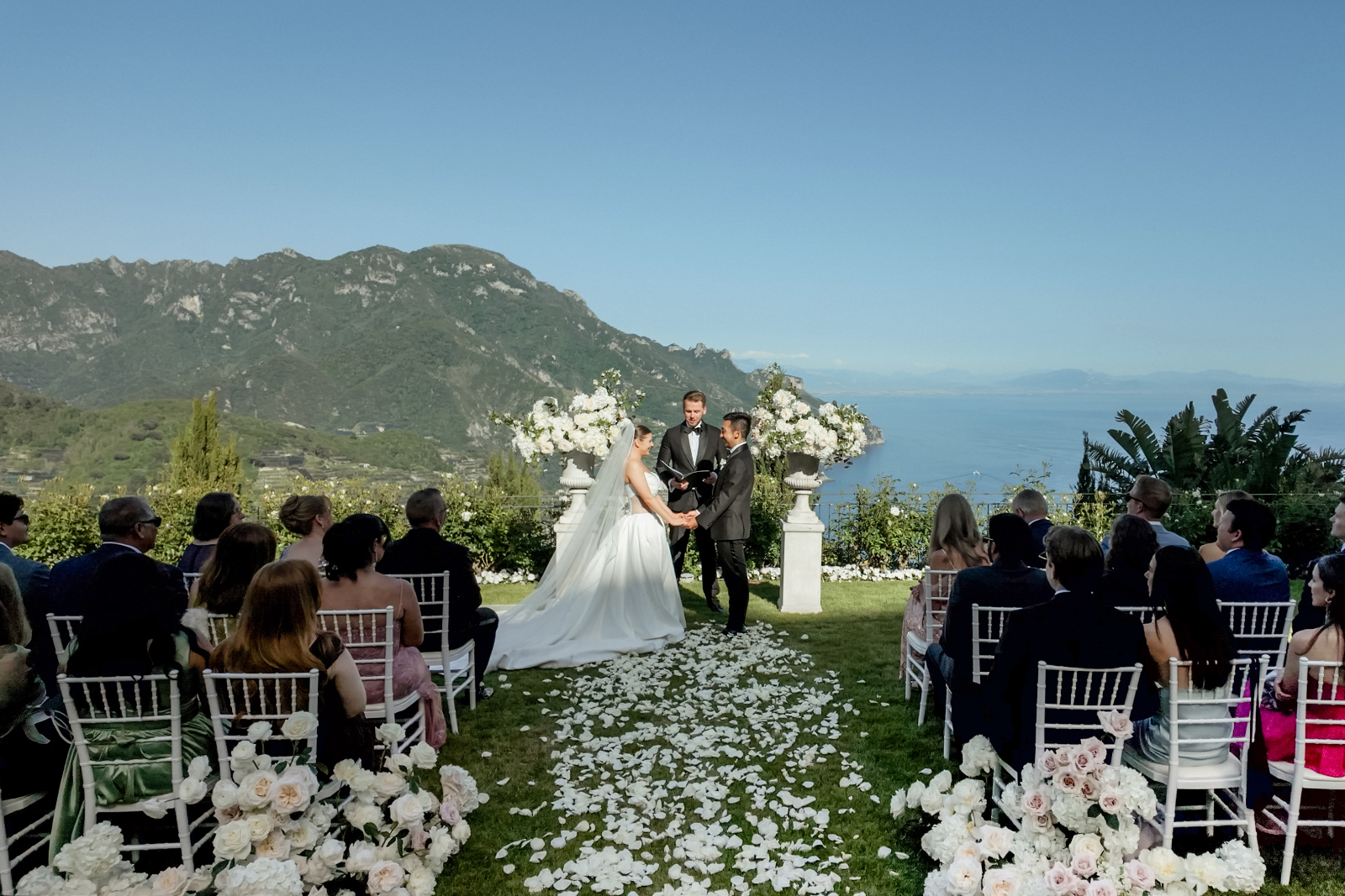 Garden ceremony setting of a Belmond Caruso Wedding in Ravello with a spectacular view of the Amalfi Coast and the mountains