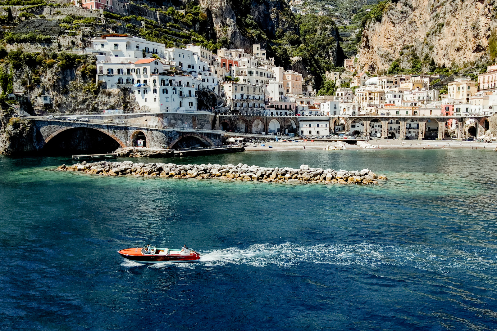 A boat tour on a Riva on the Amalfi Coast with Atrani as the backdrop